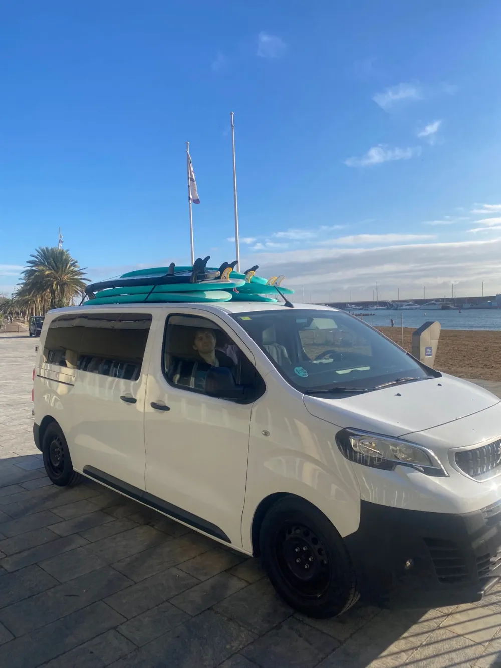 The BCN Surf School van loaded with boards next to Barceloneta beach